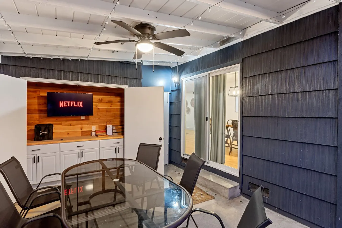 Covered patio with outdoor TV and table