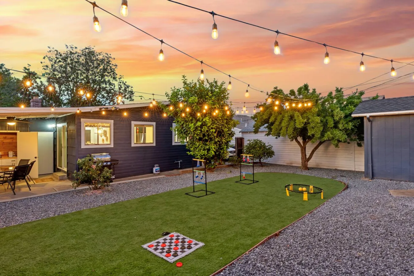 Backyard of Main Street Retreat in Roseville, California, lit by string lights at dusk