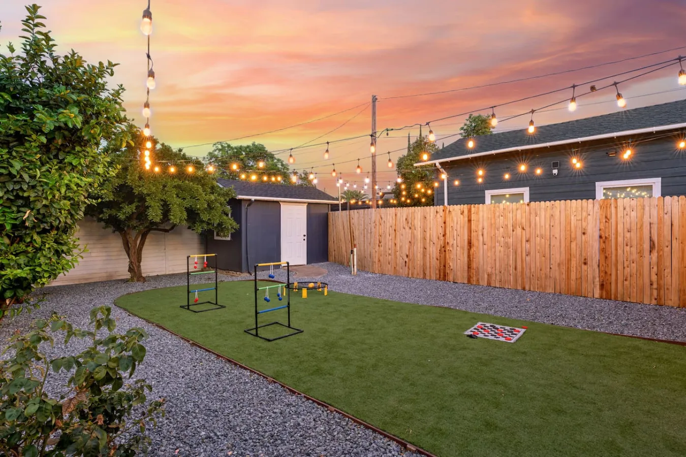 Backyard lawn under string lights at dusk